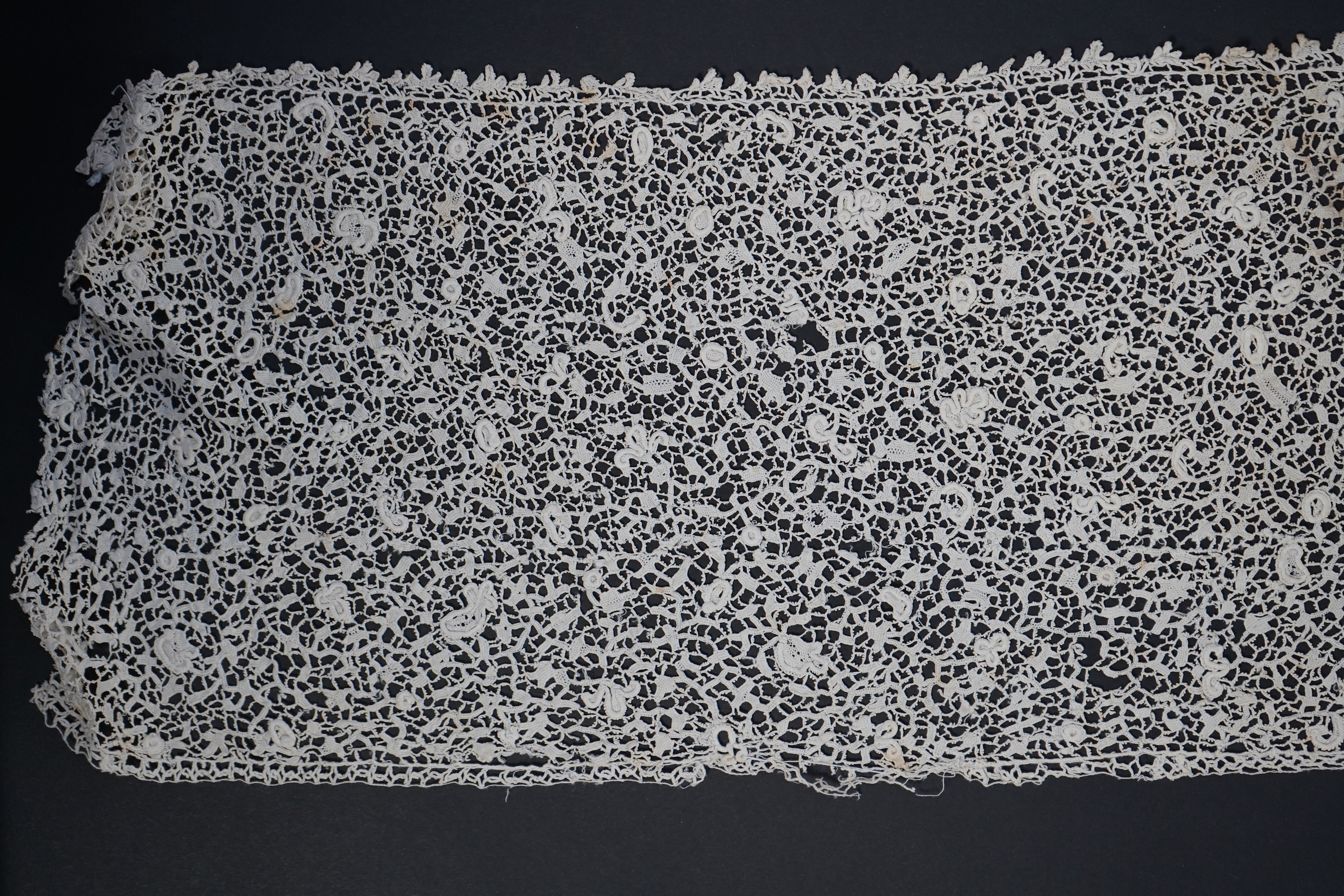 A late 17th century wide flounce of Point de France needle lace, together with a narrower flounce, both with raised elements of the design in the style of Point de Rose, but less so. This lace was very popular with the F